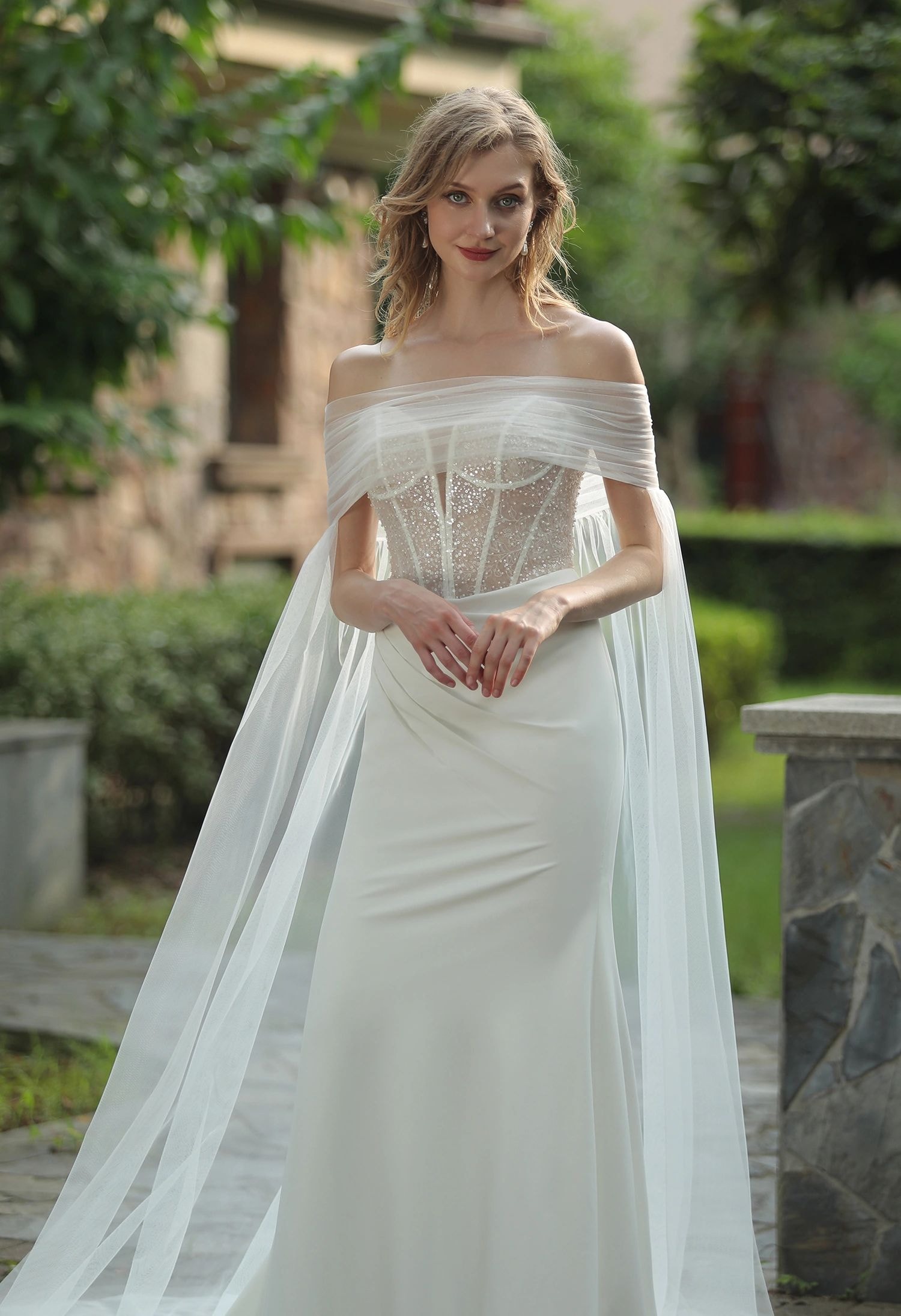Bride in a beaded crepe fit-and-flare wedding gown