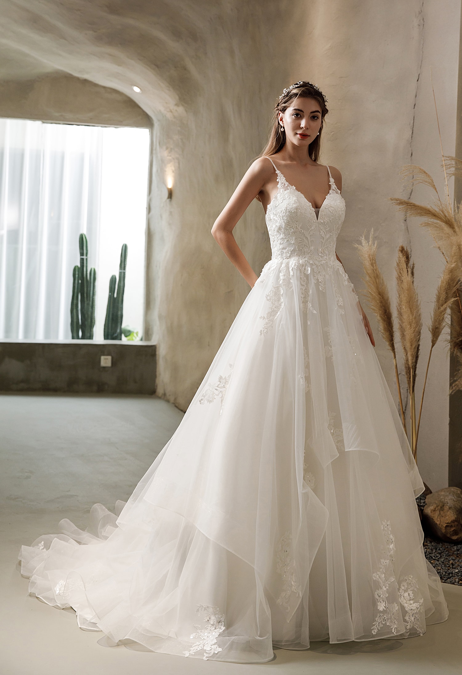Bride in a satin A-line wedding gown holding a bouquet