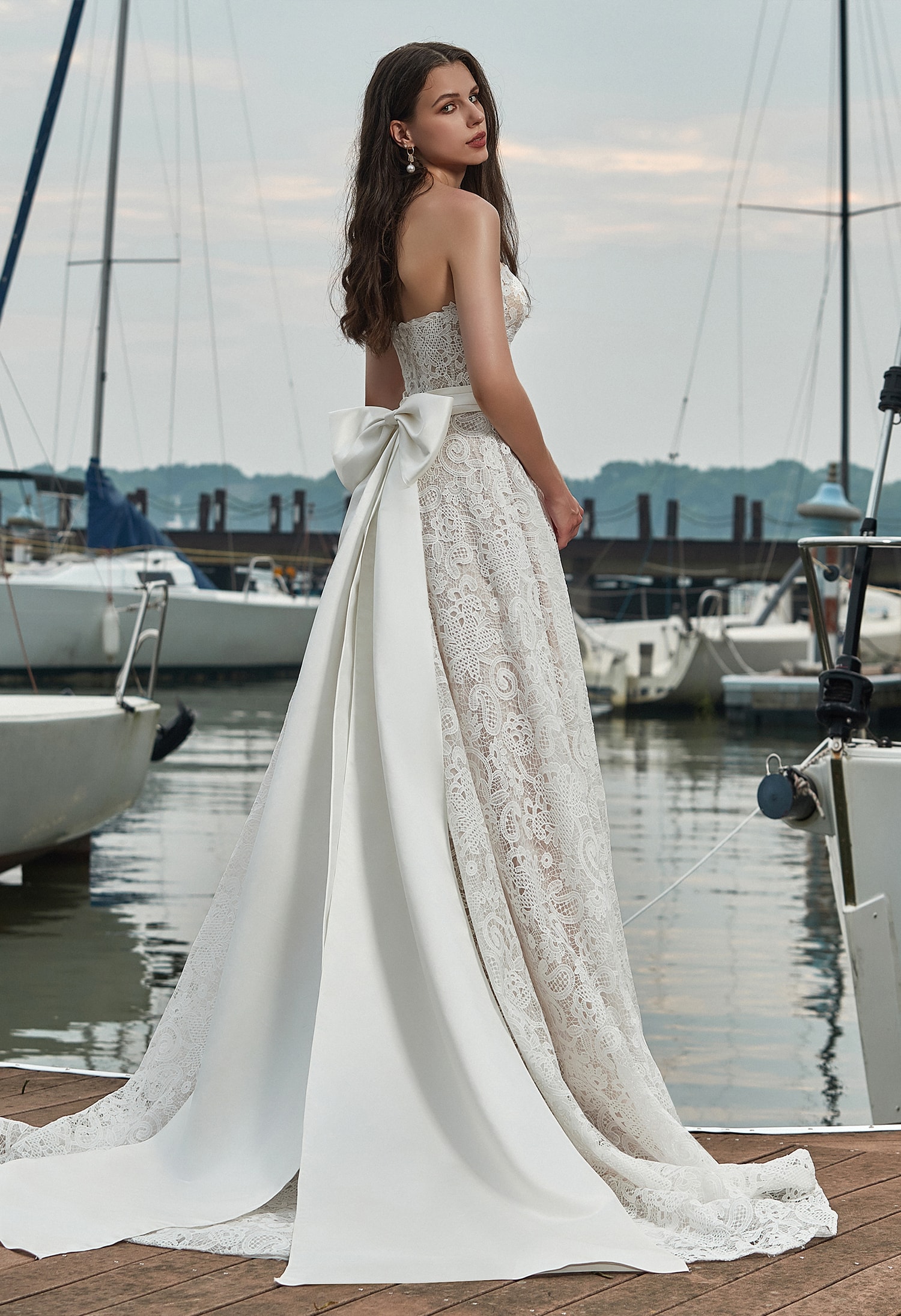 Bride in an off-shoulder floral lace wedding gown outdoors