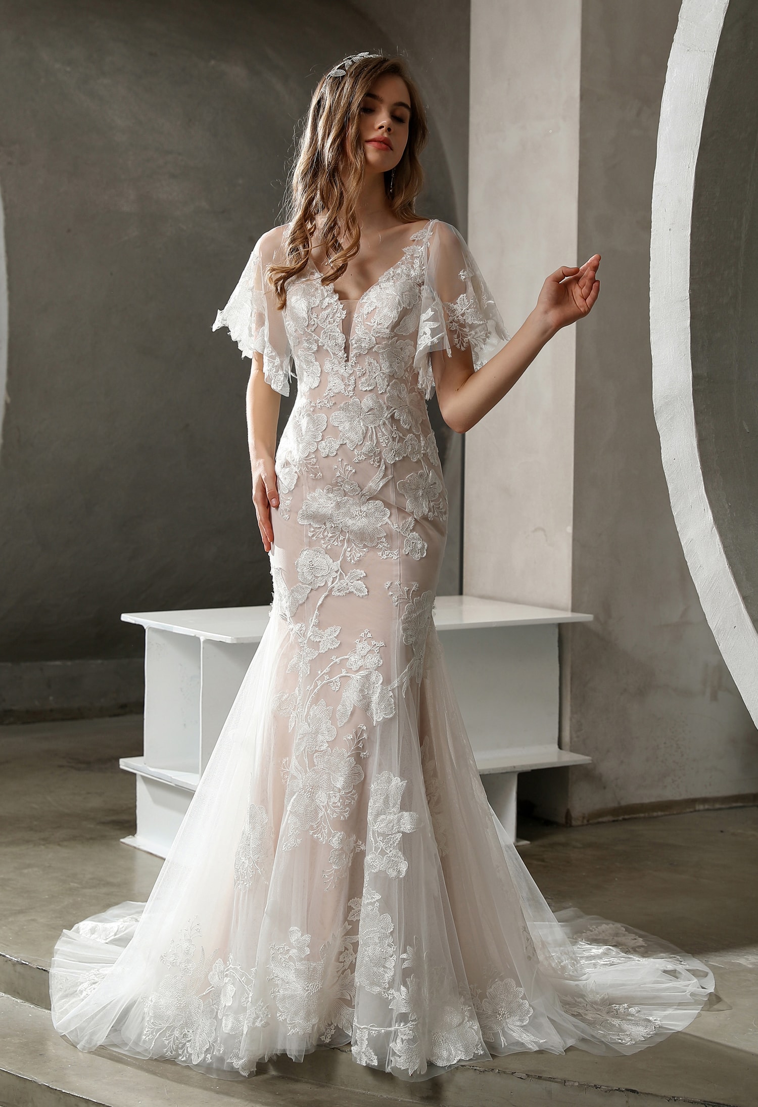 Bride with elegant updo and long veil in a white wedding gown