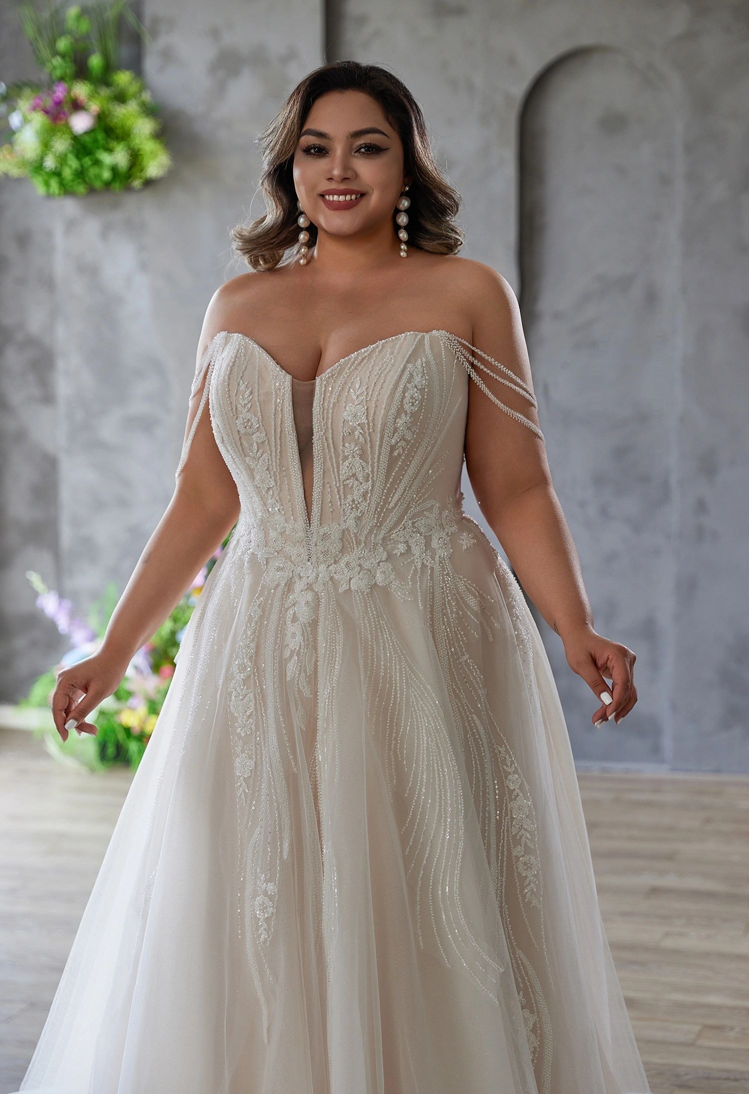 Elegant bride in an off-shoulder white wedding dress outdoors