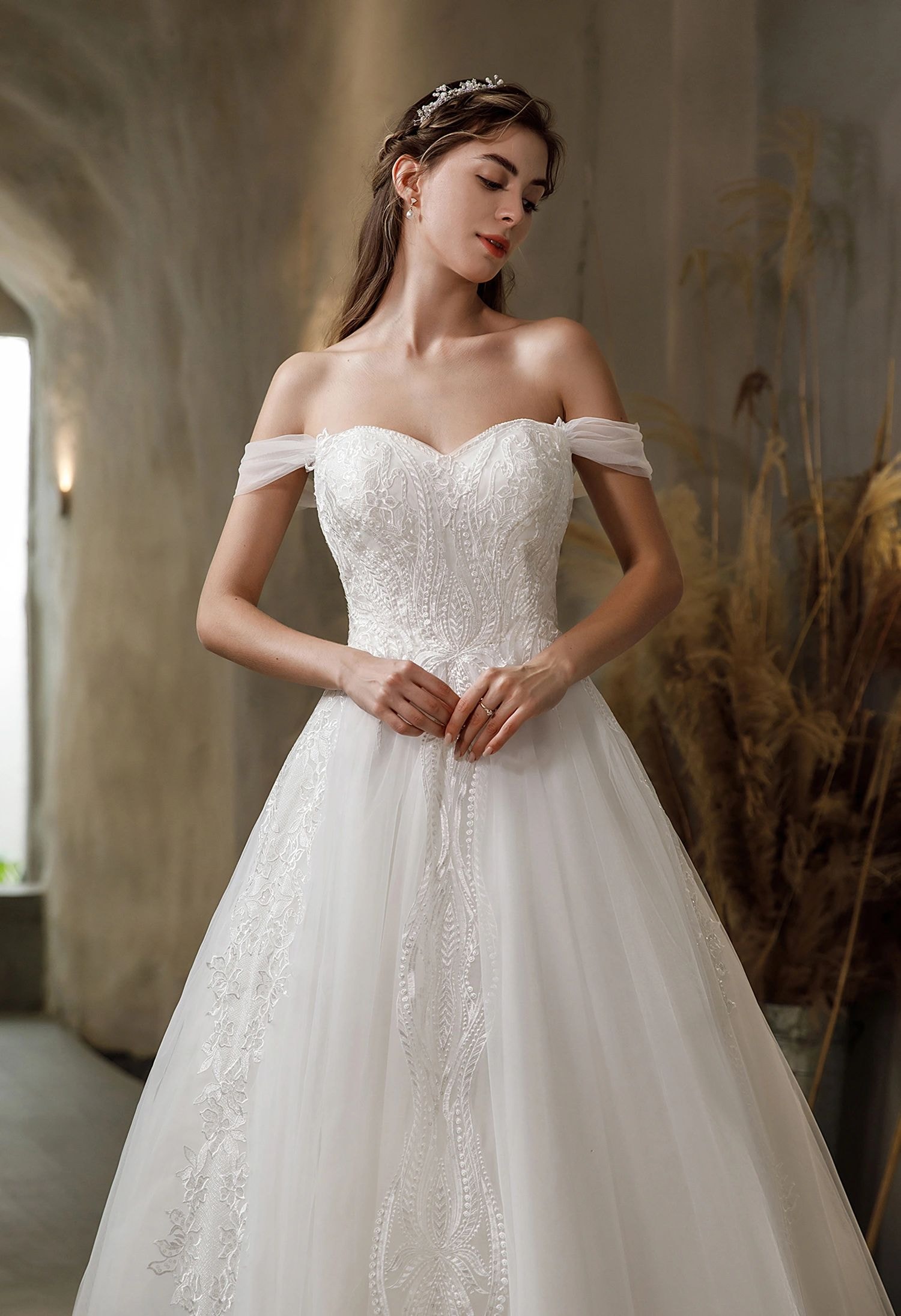 Smiling bride in a sparkling white wedding dress