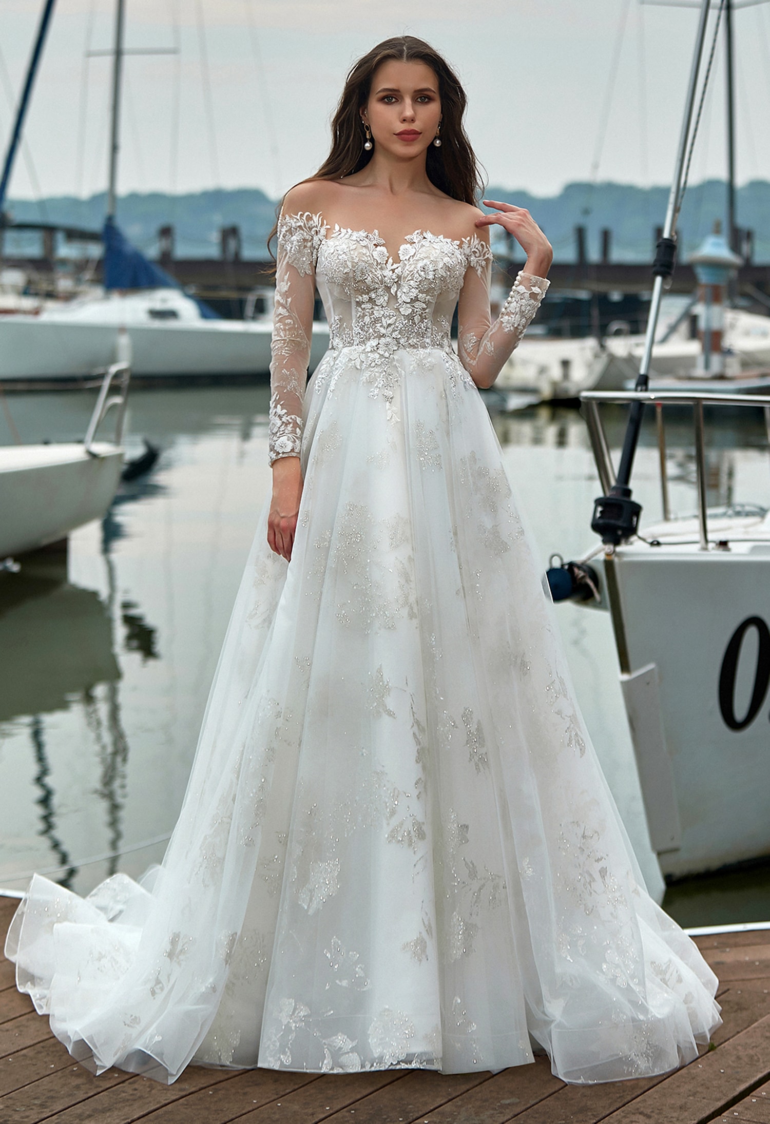 Bride in a lace long-sleeve wedding gown full length